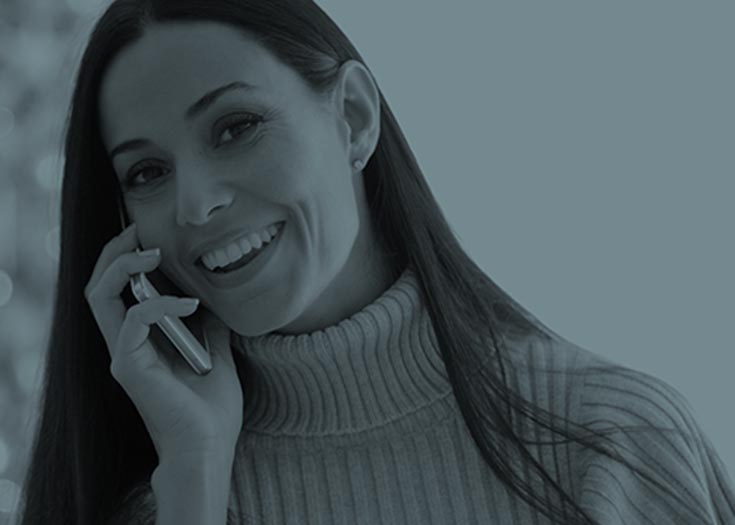 Smiling woman holding phone