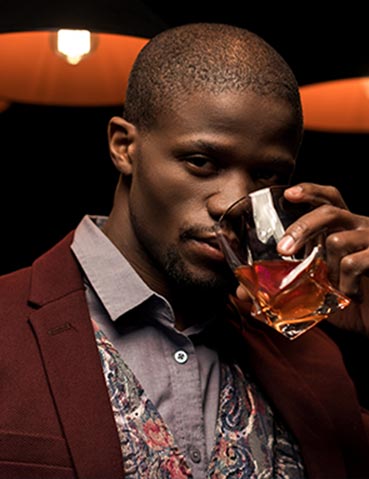 Black guy drinking cocktail